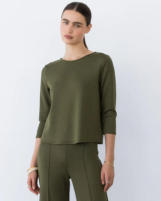 Ripley Rader Olive Ponte Knit 3/4 Sleeve Top. Model is wearing top and is posing in front of a white background. 