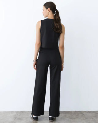 Ripley Rader Ponte Knit Vest Black. Model is turned around wearing the product and is posing in front of white background. 