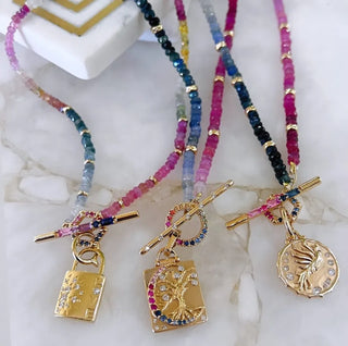 Three Stories Sparkling Sea Ombre Sapphire and Gold Beaded Chain with Round Sapphire Toggle shown in a group shot with other charms and chains