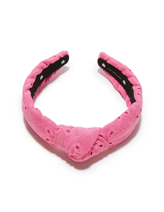 Lele Sadoughi Fuchsia Slim Knotted Eyelet Headband laid flat with visible floral embroidery details