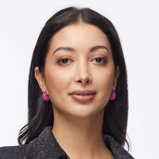 Model wearing Lele Sadoughi Flamingo Pavé Dome Mini Hoop Earrings, featuring small pink hoops covered in sparkling pavé crystals for a fun, flirty look.