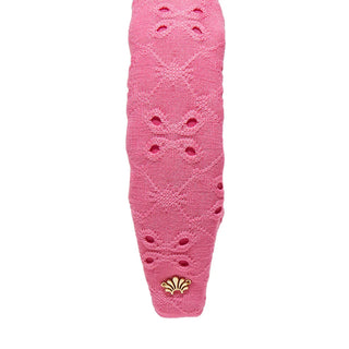Detailed view of the Lele Sadoughi headband knot showcasing fuchsia eyelet fabric and stitched floral pattern
