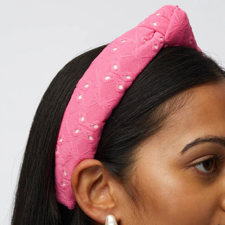 Woman wearing the Lele Sadoughi Fuchsia Slim Knotted Eyelet Headband with hair down