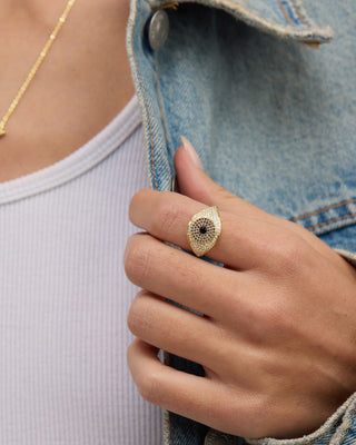 at house of 29 the model is wearing a black evil eye ring with gold and black diamondettes